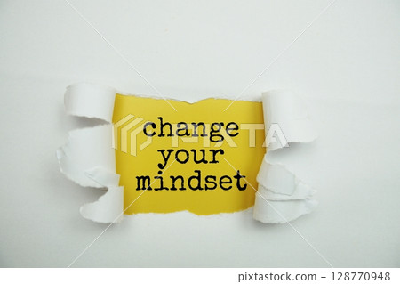 Change Your Mindset message written on yellow paper with torn paper background 128770948