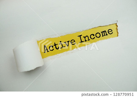 Active Income message written on yellow paper with torn paper background 128770951