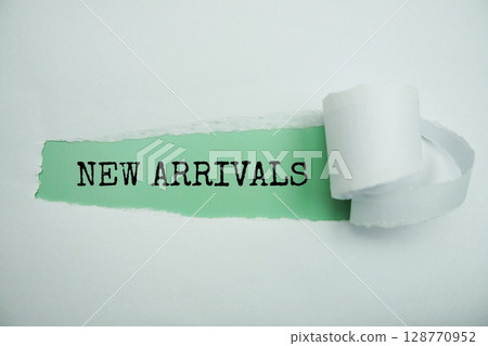 New Arrivals message written on green paper with torn paper background 128770952