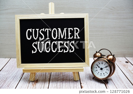 Customer Success text written on chalkboard with alarm clock on wooden background Customer Success text written on chalkboard with alarm clock on wooden background 128771026
