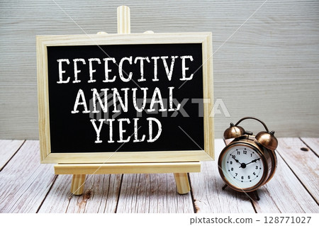 Effective Annual Yield text written on chalkboard with alarm clock on wooden background Effective Annual Yield text written on chalkboard with alarm clock on wooden background 128771027