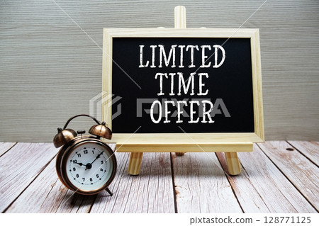 Limited Time Offer text written on chalkboard with alarm clock on wooden background 128771125