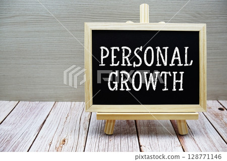 Personal Growth text written on chalkboard with easel on wooden background Personal Growth text written on chalkboard with easel on wooden background 128771146