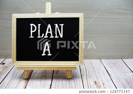 Plan A text written on chalkboard with easel on wooden background 128771147