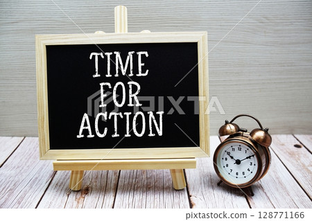 Time for Action text written on chalkboard with alarm clock on wooden background 128771166