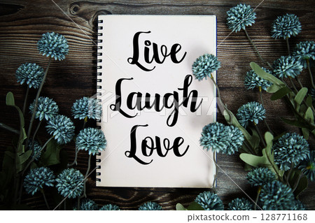 Live Laugh Love text with flowers decoration on wooden background 128771168