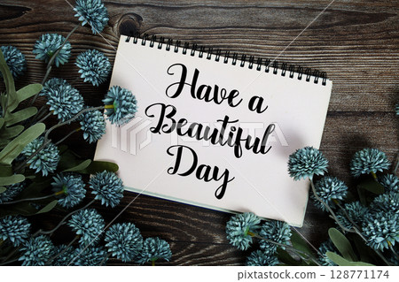 Have a Beautiful Day text with flowers decoration on wooden background 128771174