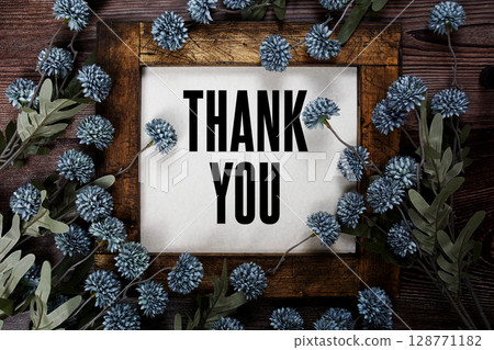 Thank You text with flowers decoration on wooden background 128771182