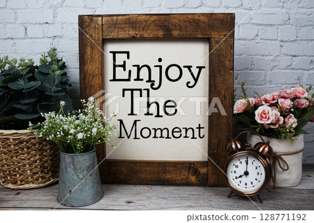 Enjoy The Moment Motivational and Inspirational quotes on wooden background Enjoy The Moment Motivational and Inspirational quotes on wooden background 128771192