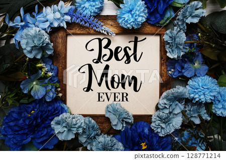 Best Mom Ever text with flowers bouquet decoration on wooden background 128771214