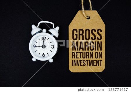 Gross Margin Return On Investment text on price tag with alarm clock on black background Gross Margin Return On Investment text on price tag with alarm clock on black background 128771417