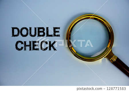 Double Check text with magnifying glass on blue background Double Check text with magnifying glass on blue background 128771583