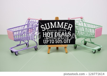 Summer Hot Deals 50% off text with mini trolley shopping cart on green background 128771614