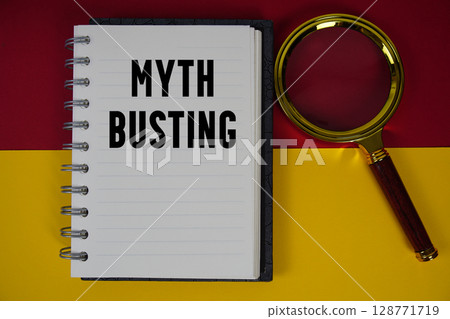 Myth Busting text written on notebook paper with magnifying glass Myth Busting text written on notebook paper with magnifying glass 128771719