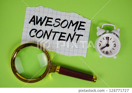 Awesome Content text written on paper with magnifying glass and alarm clock Awesome Content text written on paper with magnifying glass and alarm clock 128771727