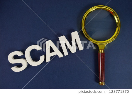 Scam letters with magnifying glass flat lay on blue background Scam letters with magnifying glass flat lay on blue background 128771870