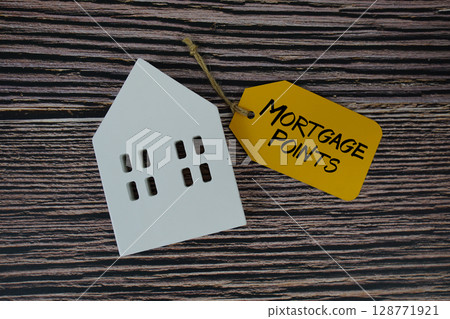 Mortgage Points text on price tag with white house model flat lay on wooden background 128771921
