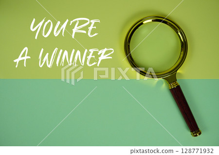 You are A Winner text with magnifying glass on green background 128771932