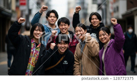 Pumping one's fist in the air with friends 128772375