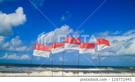 Indonesia asia flags on the beach with beautiful blue sky. Independen day and summer vacation concept  128772945