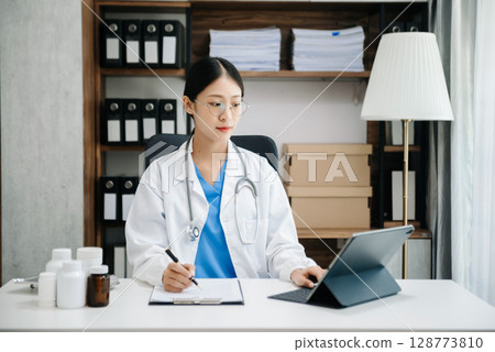 Medicine doctor hand working with modern digital tablet computer interface as medical network concept Medicine doctor hand working with modern digital tablet computer interface as medical network concept 128773810