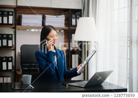 Woman freelancer is working her job on computer tablet and laptop Doing accounting analysis report real estate investment data, Financial 128773850