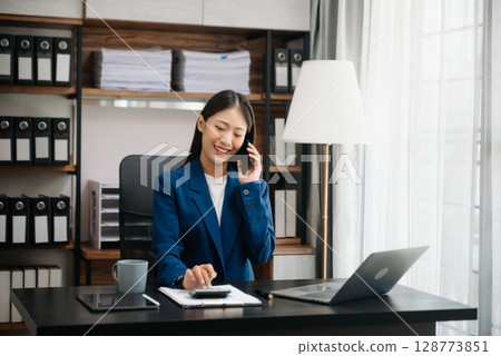 Woman freelancer is working her job on computer tablet and laptop Doing accounting analysis report real estate investment data, Financial Woman freelancer is working her job on computer tablet and laptop Doing accounting analysis report real estate investment data, Financial 128773851