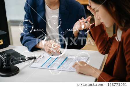 Copyright or patent concept, Business team analyzing data and using smart phone and tablet with virtual screen copyright icon trademark license, Creation ownership against piracy. at office 128773961