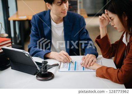 Business law concept, Lawyer business lawyers are consulting lawyers for women entrepreneurs to file copyright lawsuit with laptop and tablet at office 128773962