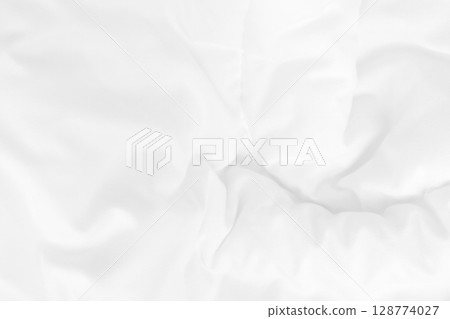 Close up top view of white bedding sheet and wrinkle messy blanket in bedroom after wake up in the morning. 128774027