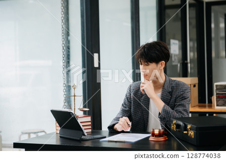 justice and law concept.Male judge in a courtroom on table and Counselor or Male lawyer working in office. justice and law concept.Male judge in a courtroom on table and Counselor or Male lawyer working in office. 128774038