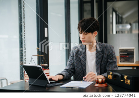 justice and law concept.Male judge in a courtroom on table and Counselor or Male lawyer working in office. 128774041