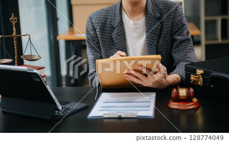 justice advice and law judge legislation concept. tribunal Attorney lawyer working with documents and white gavel on tabel justice advice and law judge legislation concept. tribunal Attorney lawyer working with documents and white gavel on tabel 128774049