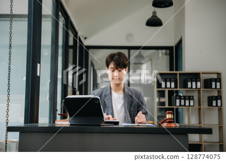 justice and law concept.Male judge in a courtroom on table and Counselor or Male lawyer working in office. justice and law concept.Male judge in a courtroom on table and Counselor or Male lawyer working in office. 128774075