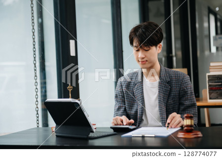 justice and law concept.Male judge in a courtroom on table and Counselor or Male lawyer working in office. justice and law concept.Male judge in a courtroom on table and Counselor or Male lawyer working in office. 128774077