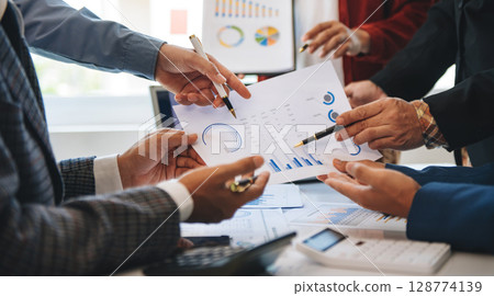 Business team collaboration discussing working analyzing with financial data and marketing growth report graph in team, presentation and digital tablet, laptop 128774139