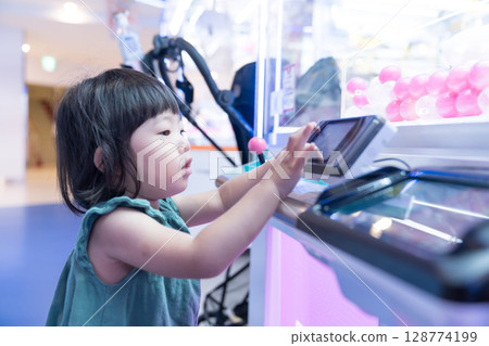 幼兒女孩在遊戲中心玩不明飛行物捕手 128774199