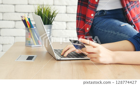 Two friends shopping using credit card online shopping on website laptop e-commerce website with smiling face, happiness. Happy asian women using laptop shopping online buy, payment newnormal concept Two friends shopping using credit card online shopping on website laptop e-commerce website with smiling face, happiness. Happy asian women using laptop shopping online buy, payment newnormal concept 128774427