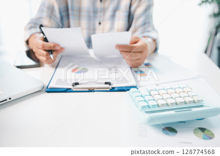 Woman calculating monthly home expenses, taxes, bank account balance and credit card bills payment, Income is not enough for expenses. financial planning, business calculate tax, investment finance. Woman calculating monthly home expenses, taxes, bank account balance and credit card bills payment, Income is not enough for expenses. financial planning, business calculate tax, investment finance. 128774568