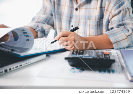 Businesswoman analysis with financial data, marketing business strategy project, Business financing accounting banking concept, finances, calculate about cost to real estate investment, tax system. Businesswoman analysis with financial data, marketing business strategy project, Business financing accounting banking concept, finances, calculate about cost to real estate investment, tax system. 128774569