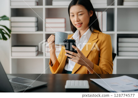 Businesswoman hand using laptop, tablet and smartphone in office. Digital marketing media mobile app and discussing plan new start up project. Finance task. Businesswoman hand using laptop, tablet and smartphone in office. Digital marketing media mobile app and discussing plan new start up project. Finance task. 128774577