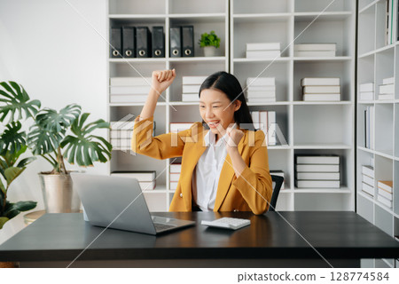Asian business woman are delighted and happy with the work they do on their tablet, laptop and taking notes at office. Asian business woman are delighted and happy with the work they do on their tablet, laptop and taking notes at office. 128774584