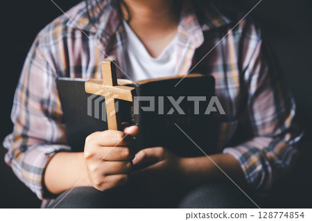 Christian woman reading bible in ancient Catholic temple. Reading Holy Bible in temple. Concept for faith, spirituality and religion. Peace, hope, Christians with holy book for worship and faith Christian woman reading bible in ancient Catholic temple. Reading Holy Bible in temple. Concept for faith, spirituality and religion. Peace, hope, Christians with holy book for worship and faith 128774854