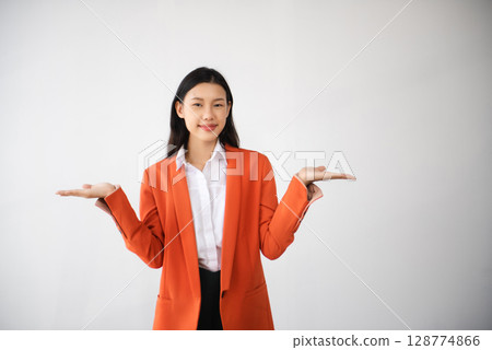 Portrait photo of young beautiful Asian woman feeling happy and holding smart phone, tablet and laptop with black empty screen on white background can use for advertising or product concept. 128774866