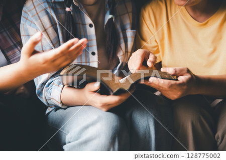 Close up group christians hands pray to God with spiritual faith on holy bible in catholic church. religion worship prayer ask god bless grace jesus believe. Christianity religion prayer holy worship 128775002