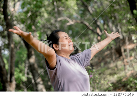 Grateful woman having HOPE praying to God. Spiritual girl smiling to sky. Happy female being thankful. Spiritual girl praying with hope. Positive asian young woman feeling hope and faith looking up. 128775149