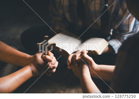 Close up group christians hands pray to God with spiritual faith on holy bible in catholic church. religion worship prayer ask god bless grace jesus believe. Christianity religion prayer holy worship Close up group christians hands pray to God with spiritual faith on holy bible in catholic church. religion worship prayer ask god bless grace jesus believe. Christianity religion prayer holy worship 128775250