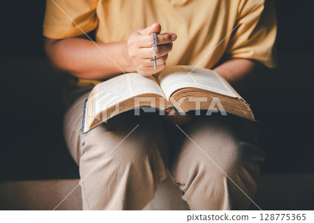 Christian woman reading bible in ancient Catholic temple. Reading Holy Bible in temple. Concept for faith, spirituality and religion. Peace, hope, Christians with holy book for worship and faith Christian woman reading bible in ancient Catholic temple. Reading Holy Bible in temple. Concept for faith, spirituality and religion. Peace, hope, Christians with holy book for worship and faith 128775365