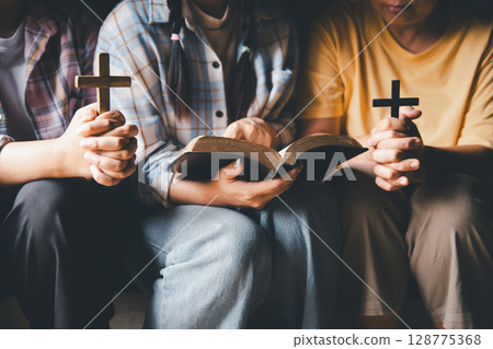 Close up group christians hands pray to God with spiritual faith on holy bible in catholic church. religion worship prayer ask god bless grace jesus believe. Christianity religion prayer holy worship Close up group christians hands pray to God with spiritual faith on holy bible in catholic church. religion worship prayer ask god bless grace jesus believe. Christianity religion prayer holy worship 128775368
