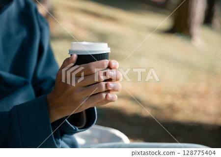 Business concept of cafe focuses on nurturing coffee in harmony with nature, organic seed create warm cup caffeine, background green fresh great outdoor. aromatic drink, rich aroma of rising from mug 128775404